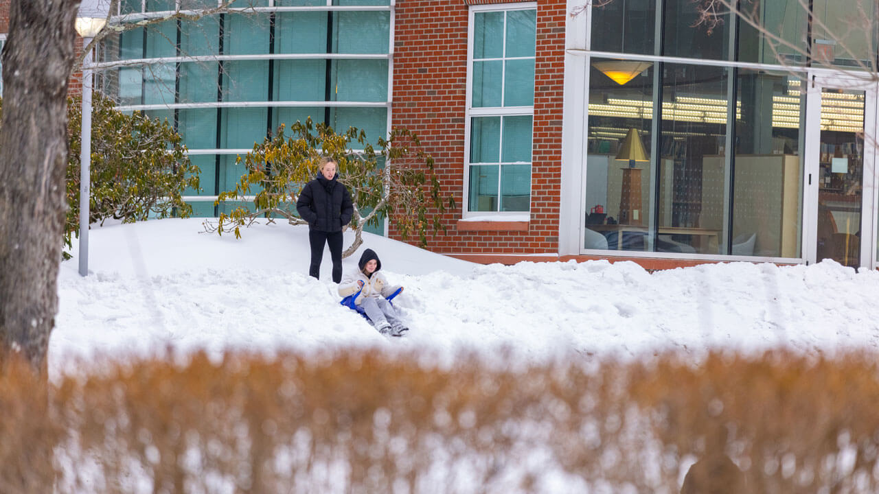 Students go sledding on the quad
