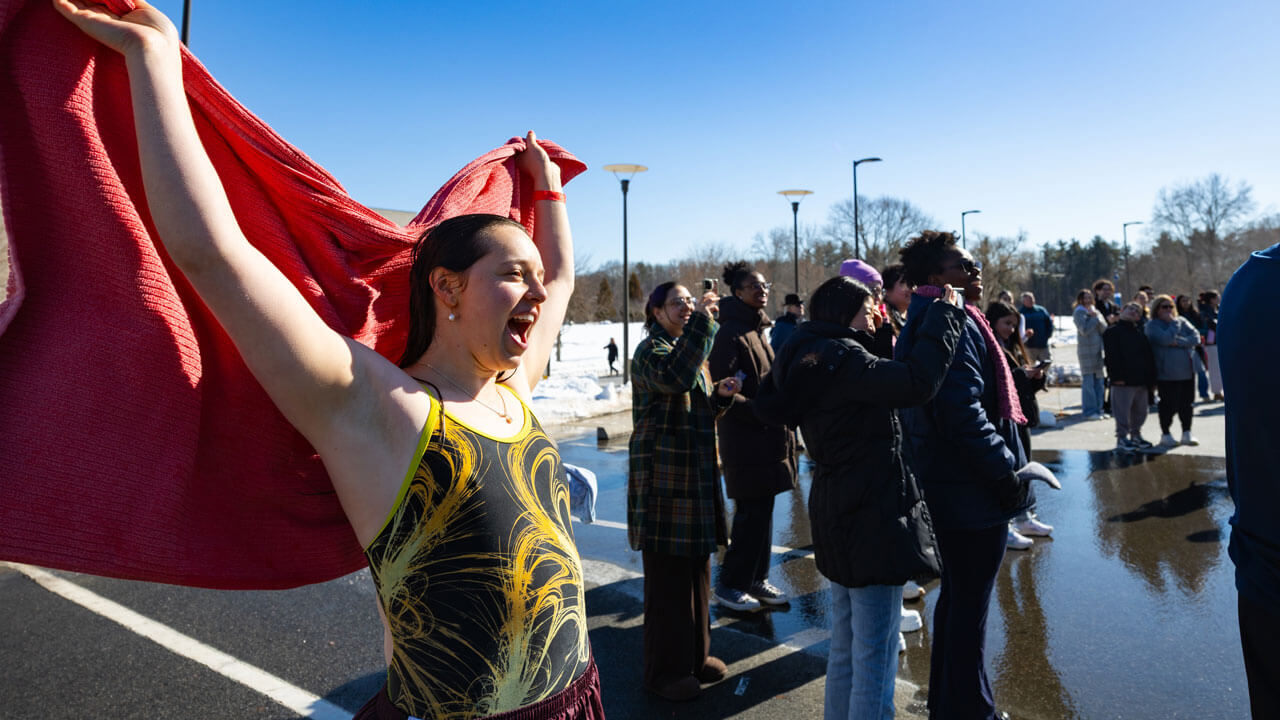 Student cheers after plunging in the dunk tank