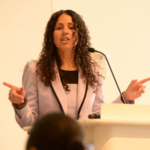 Ines Zemaitis speaks at a podium with a microphone