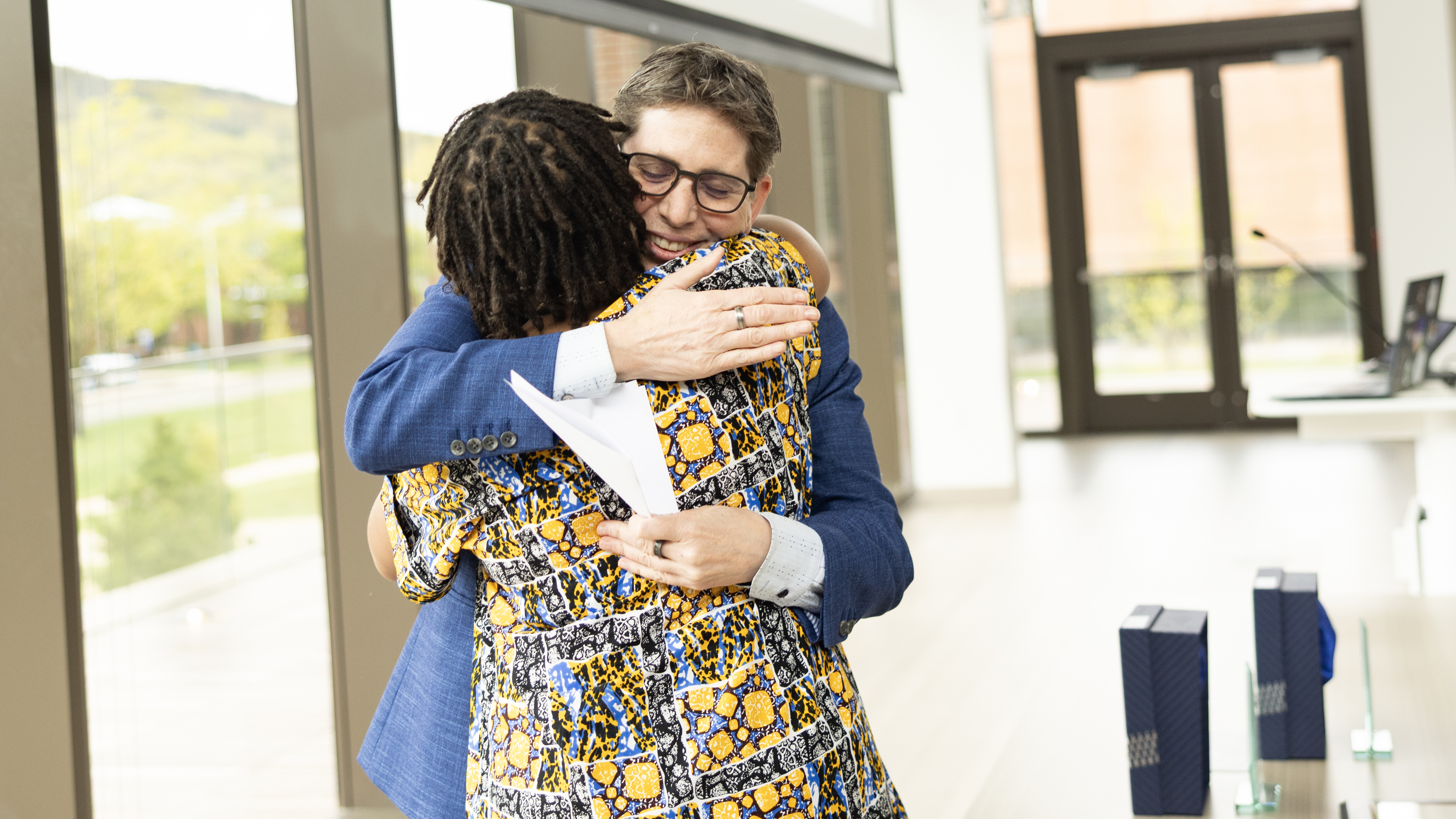 Congratulatory hug at the Quinnipiac Faculty Awards