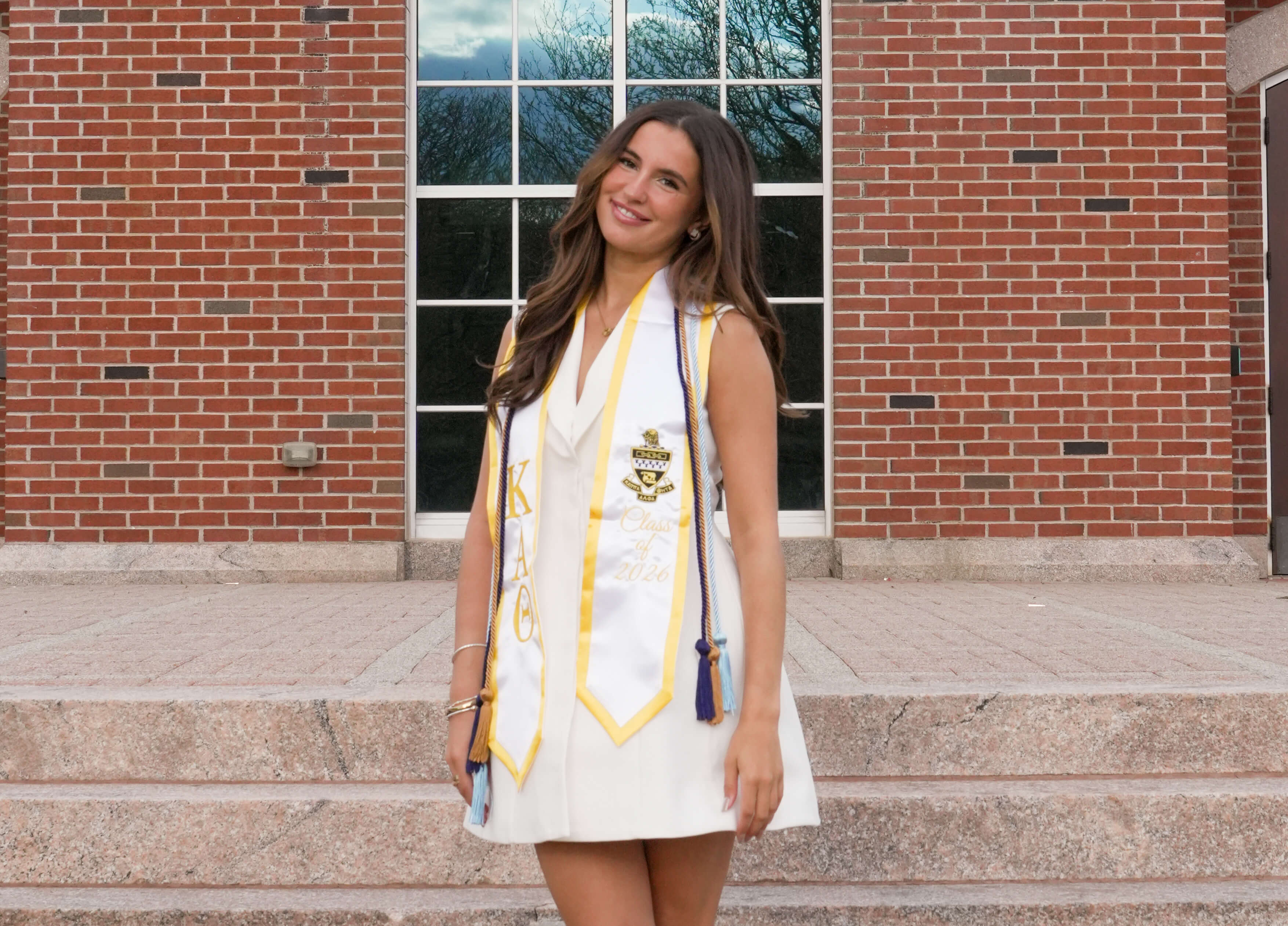 Sophia Goodrow standing in front of Arnold Bernhard Library