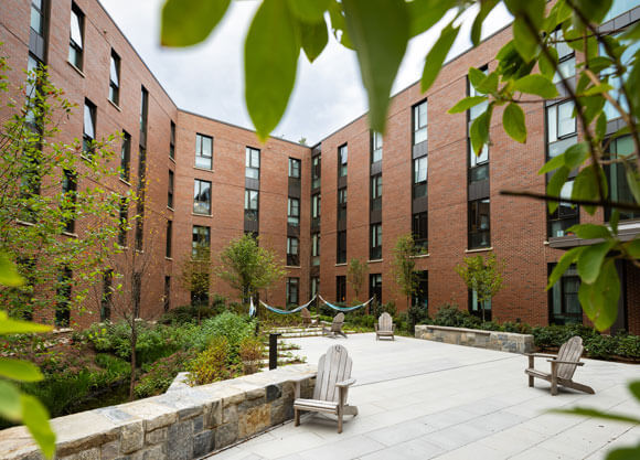 Lush trees fill a courtyard at The Grove residences