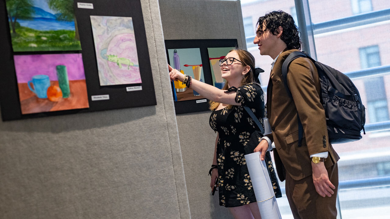 Students admire art work of fellow students