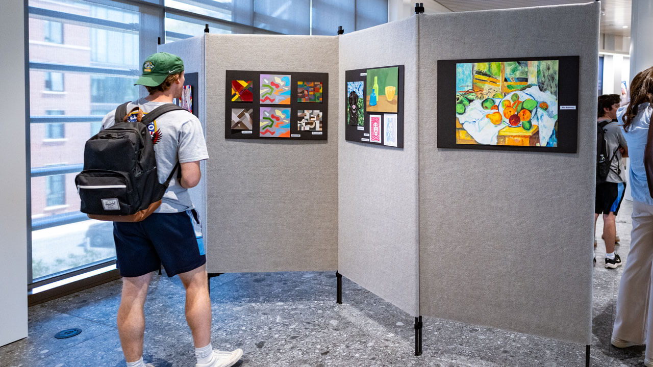 Students walk through gallery of artwork