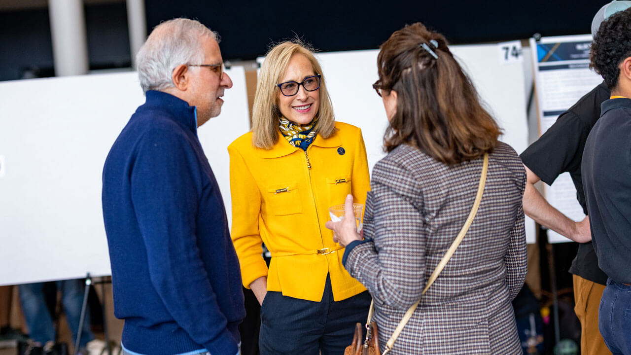 People converse at event