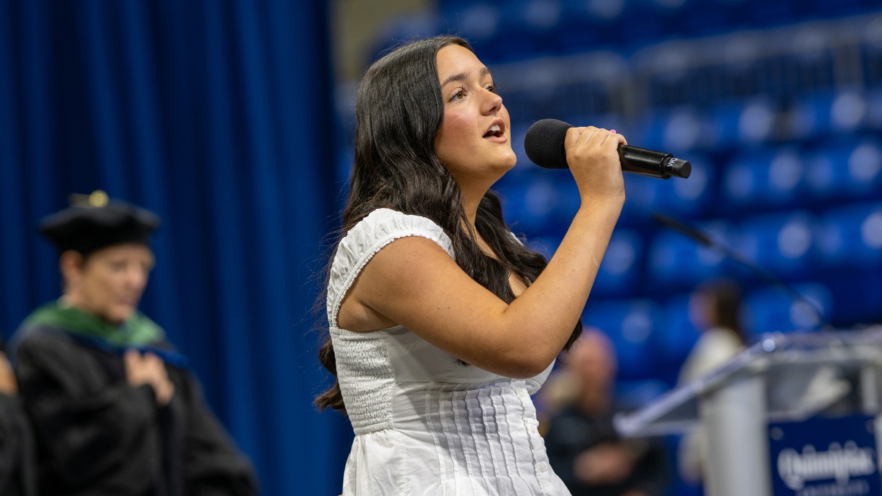 Addison Prunier sings the National Anthem at commencement