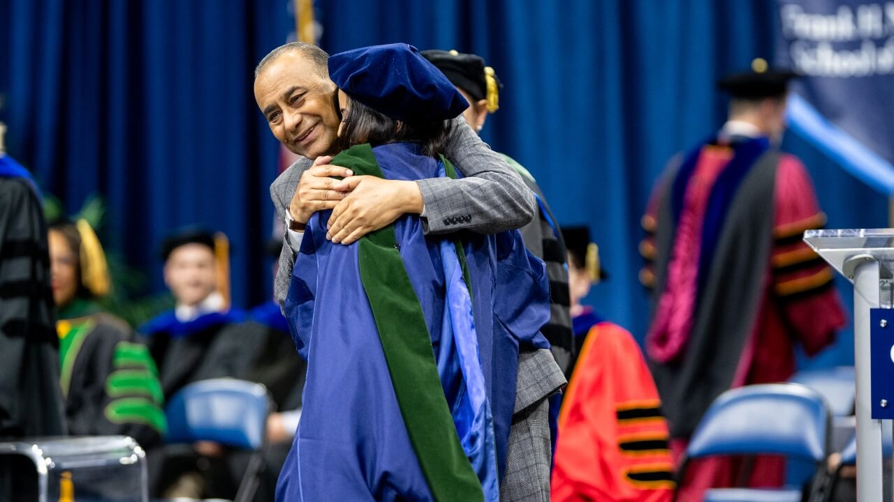 Guest and graduate embracing