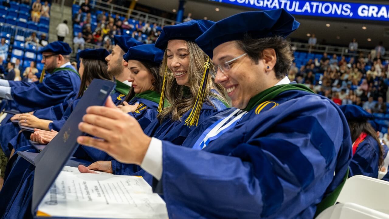 Graduate admiring degree