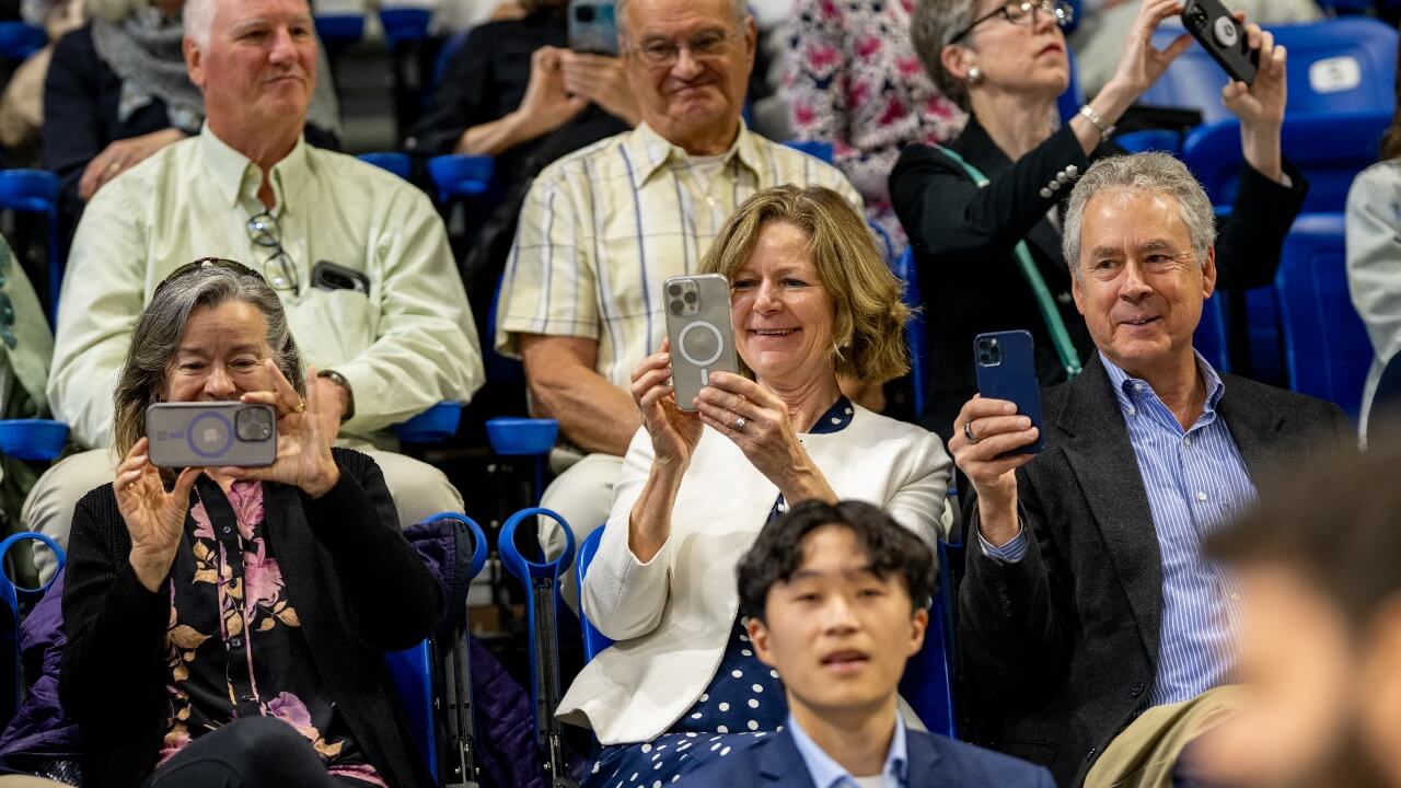 Crowd takes pictures of graduates