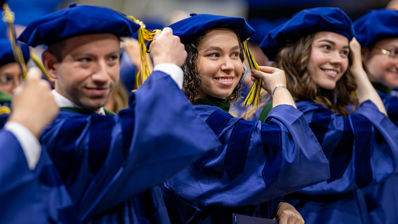 Graduates move their tassels at commencement