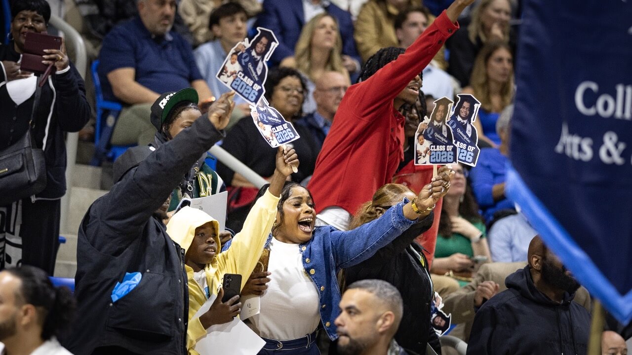 Families show their excitement with cardboard cutouts of their graduate