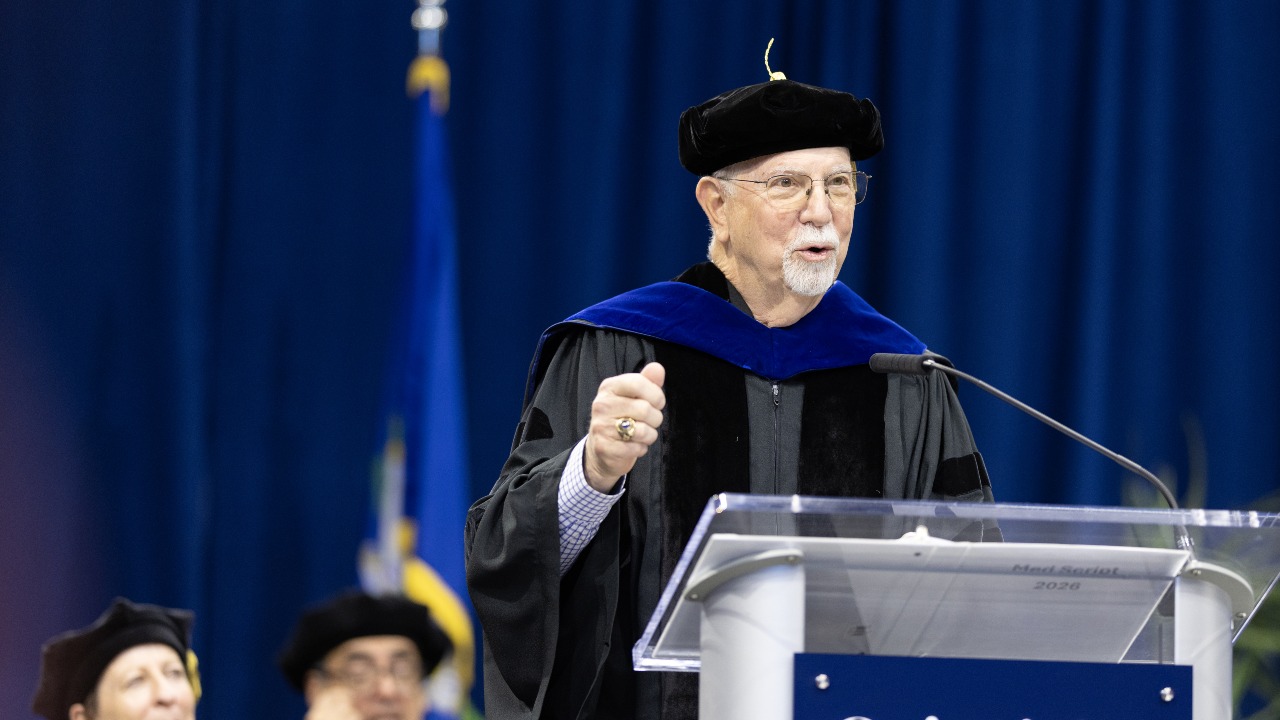 Robert Passero addresses graduates at podium