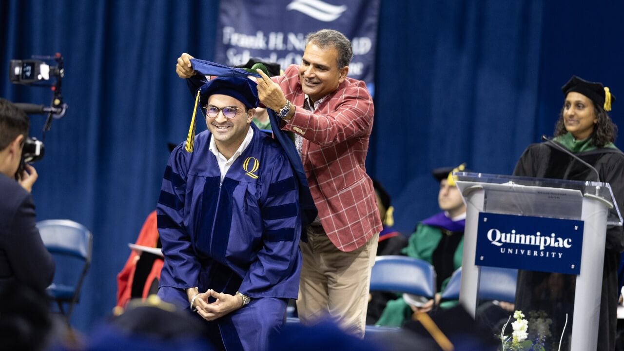 Graduate received their hood on stage.