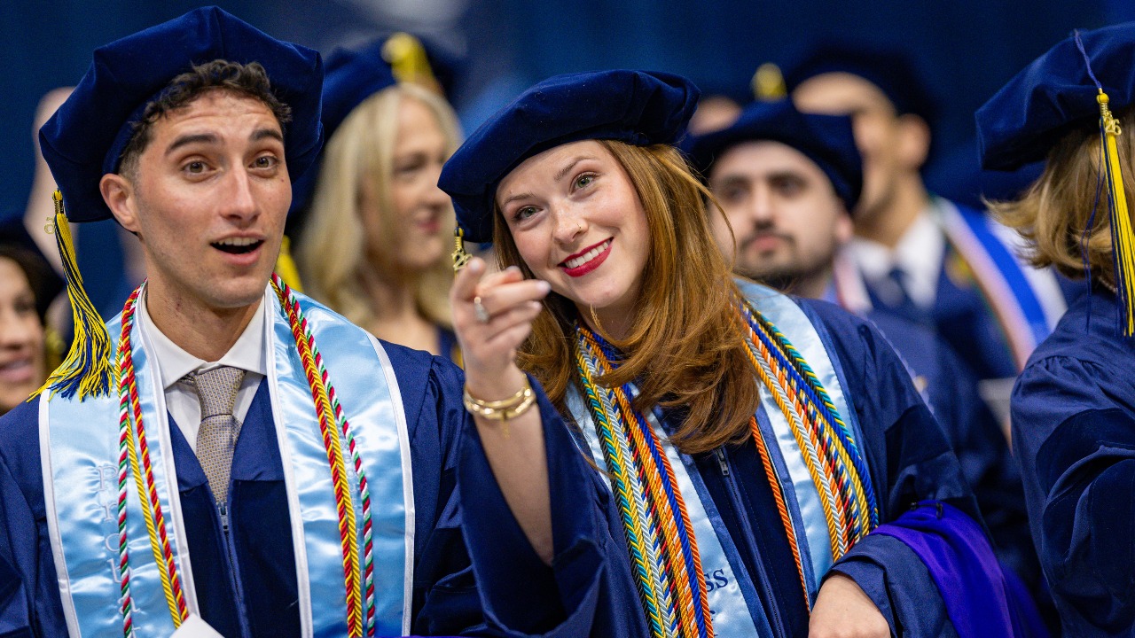 Graduating law student points and laughs