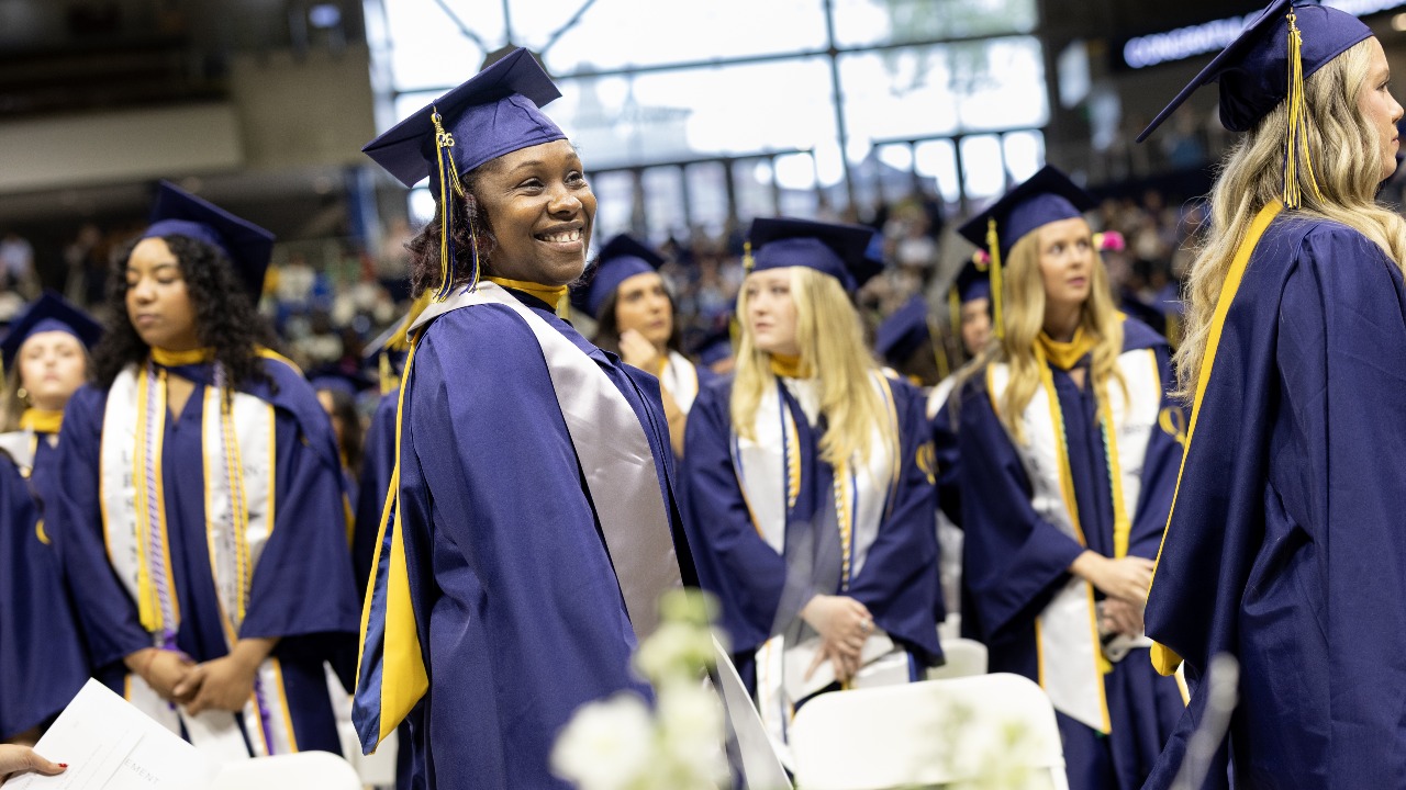 Graduate looks right while dresses in cap and gown