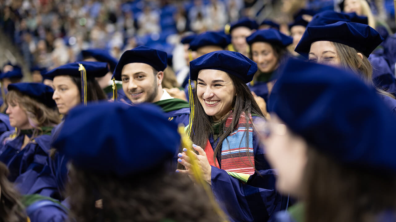 Graduate section of audience happily sitting together during the ceremony