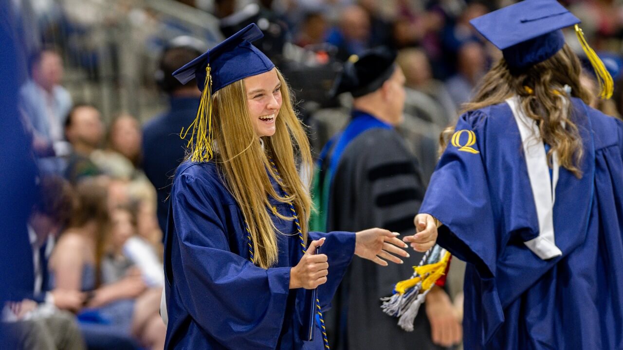 Graduate looking to the right and smiling