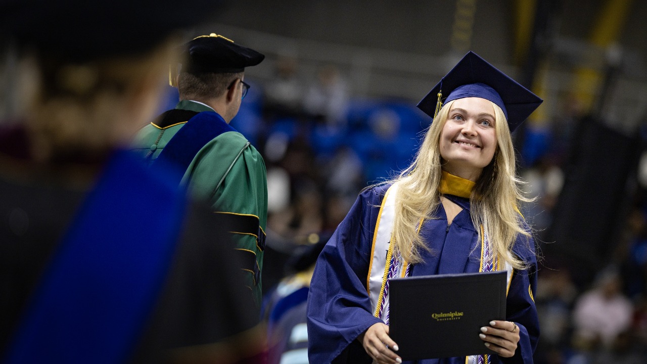 Graduate smiles after walking the stage