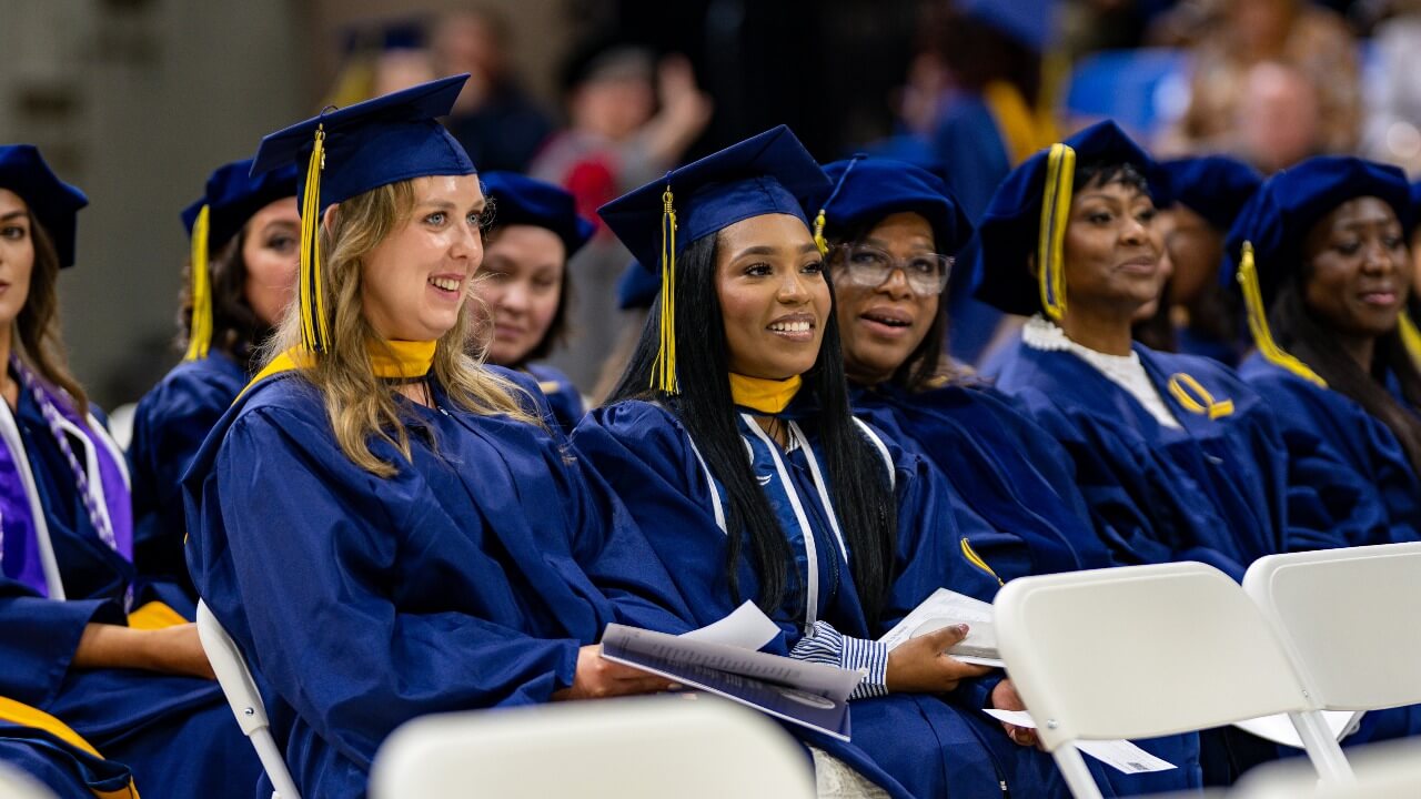Graduates enjoy commencement sitting next to their fellow peers
