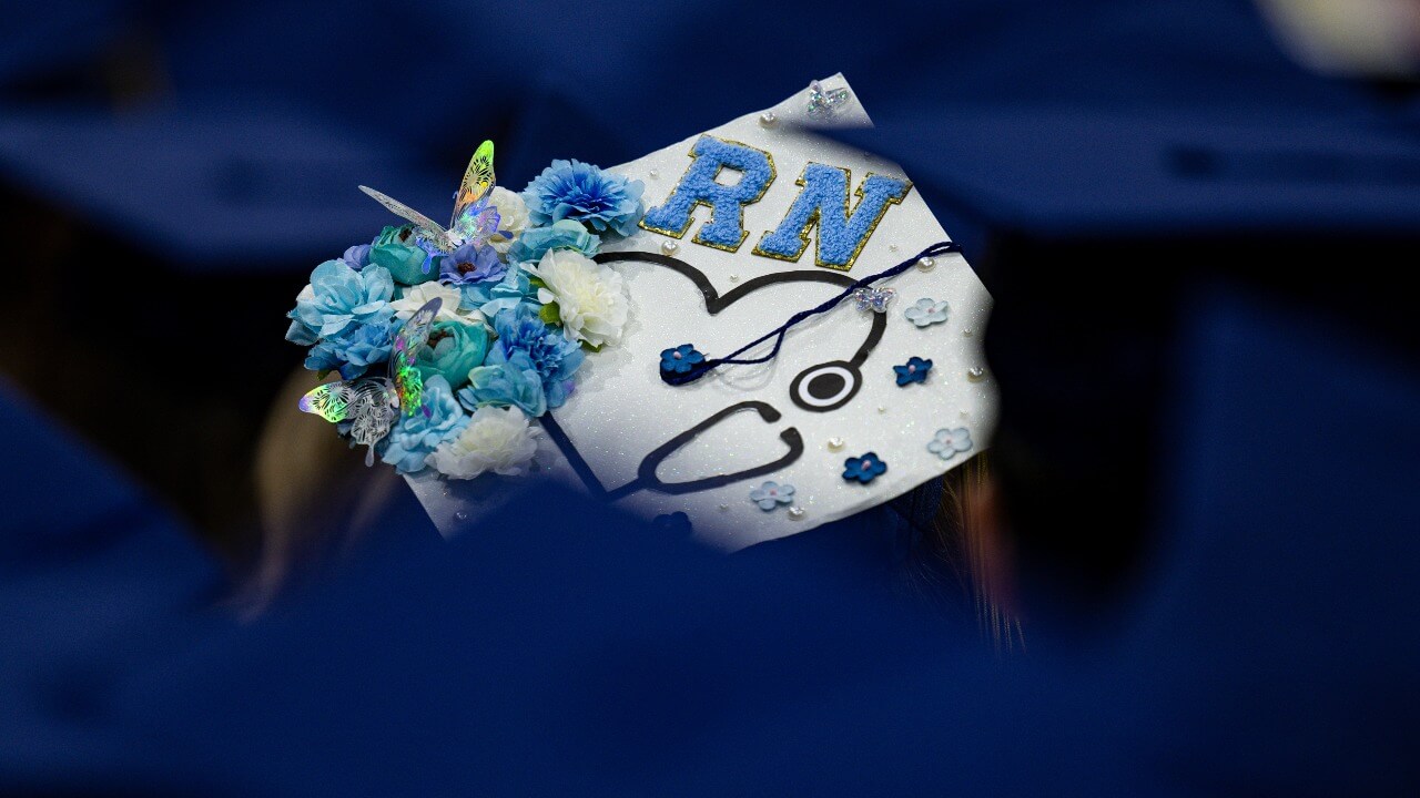 A close-up of a School of Nursing graduate's cap design