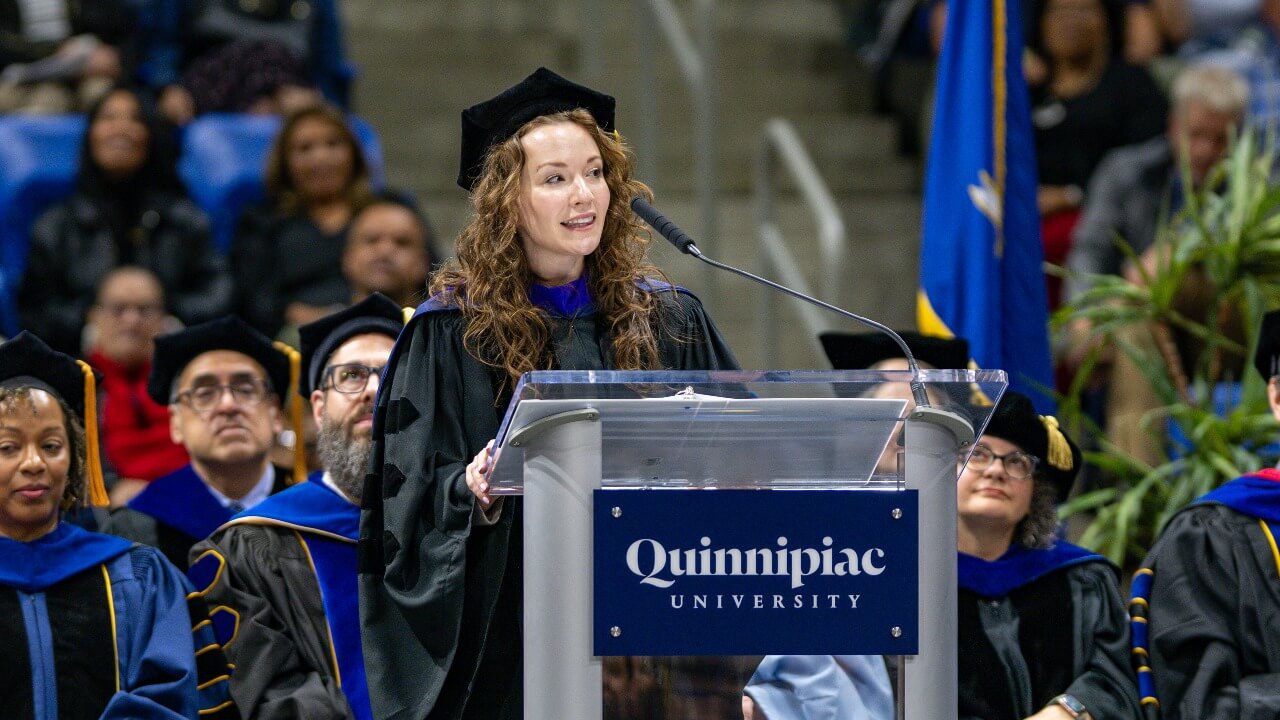 Jennifer Lepore stands at the podium to address the new graduates