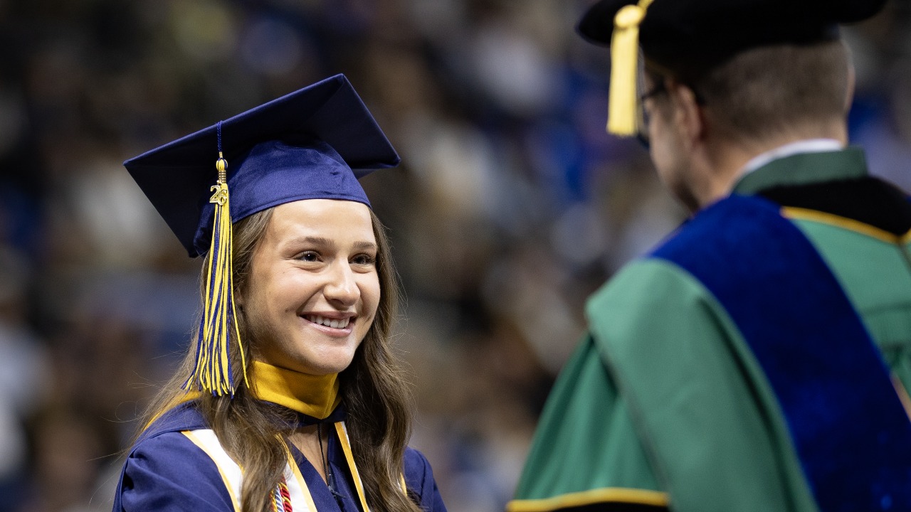 Graduate smiles on stage