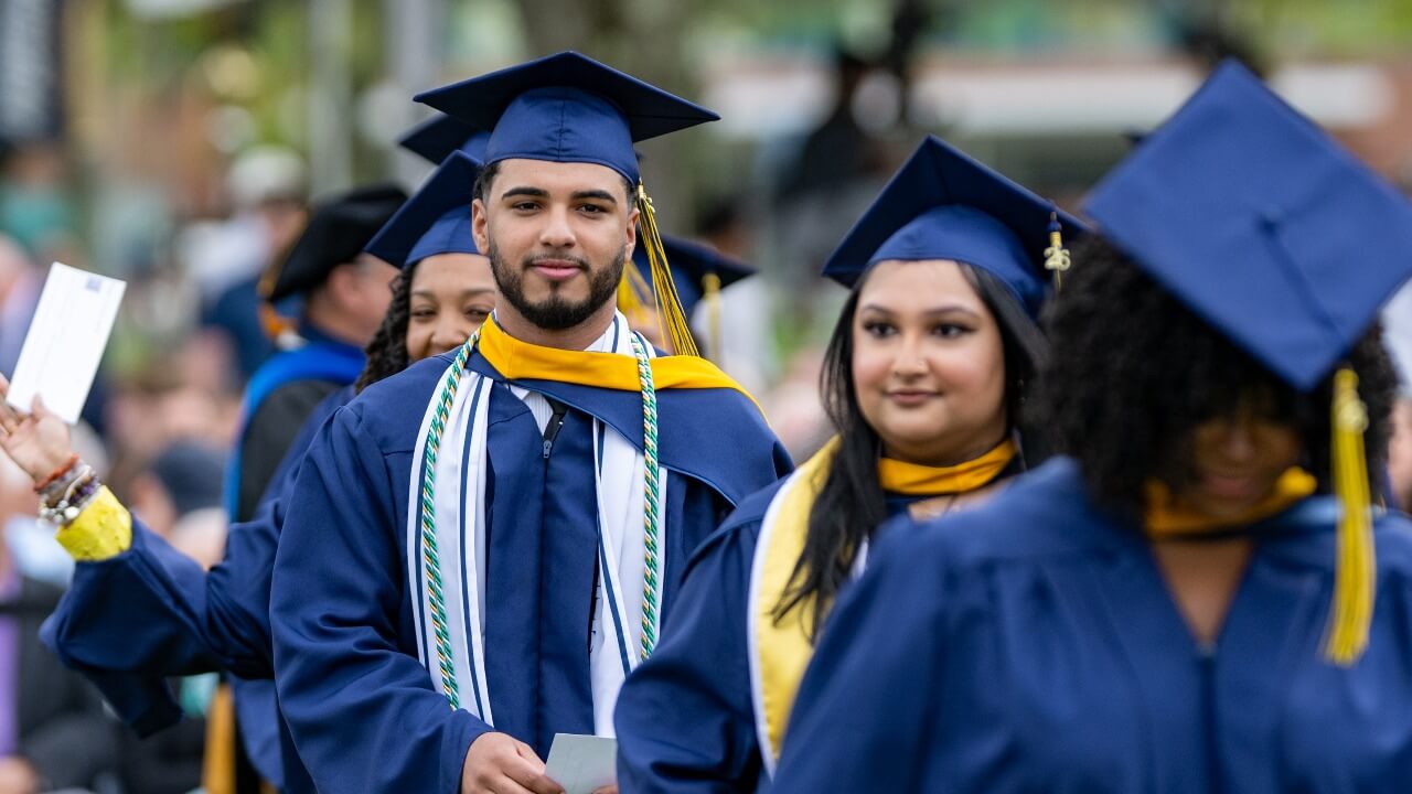 Several graduates processing off the stage
