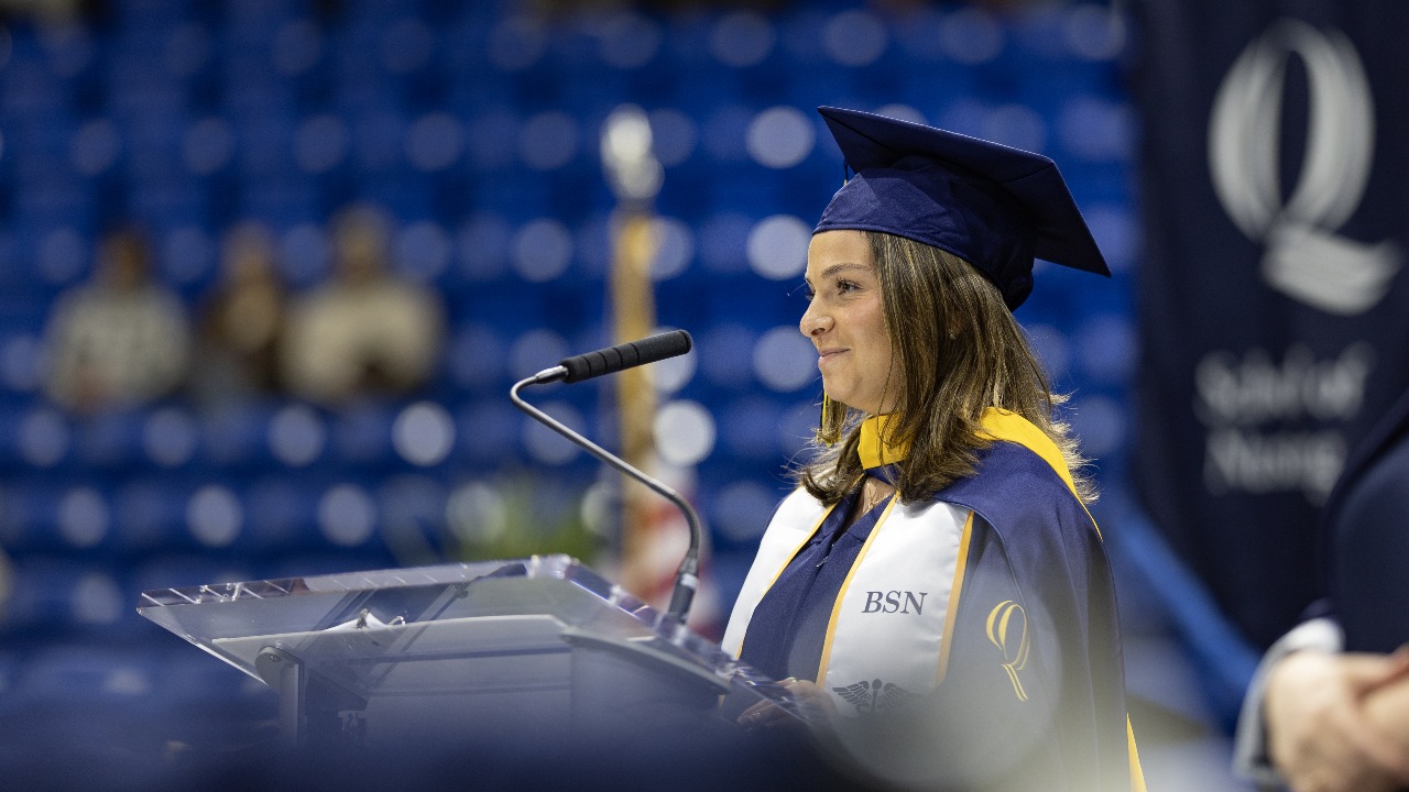 Marie Urrea gives a speech at commencement from the podium