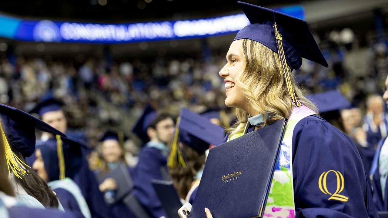 Graduating student looks left