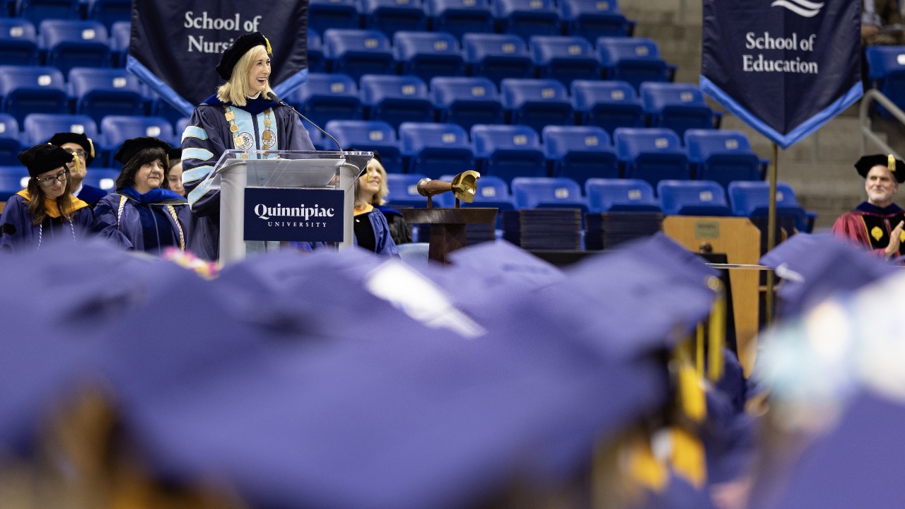 President Marie Hardin looks out over a crowd of graduates at commencement