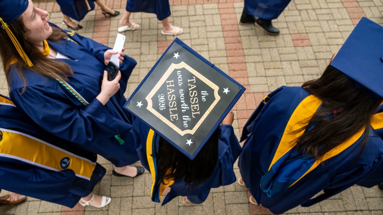 Birds Eye view of graduation cap decorated with the words "the tassel was worth the hassle 2026"