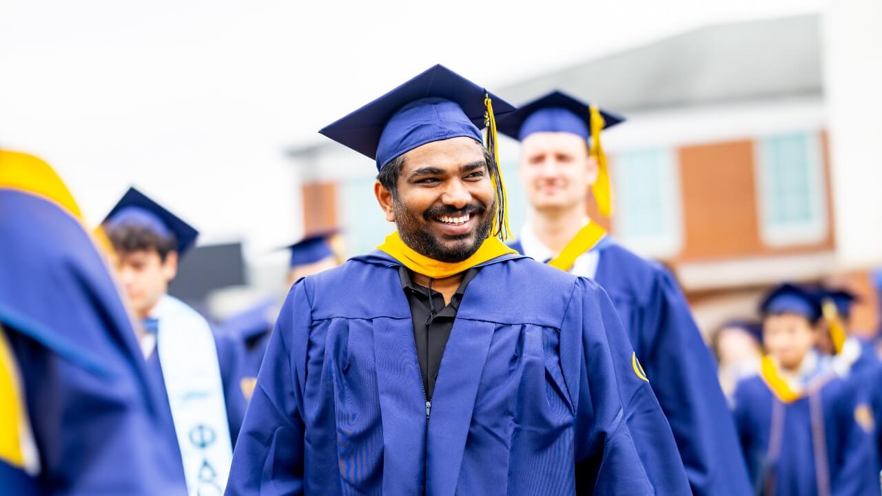 Graduate looking to the right and smiling