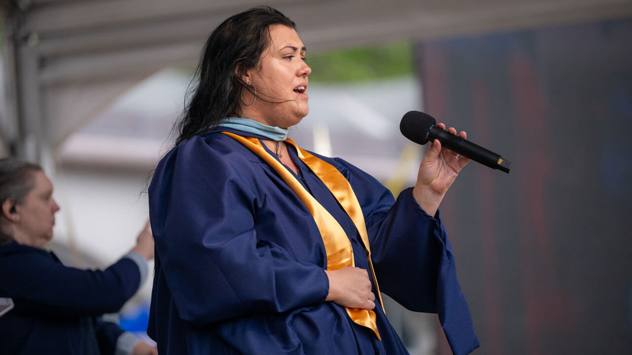Anna Bond Hilbie sings the national anthem for graduates.