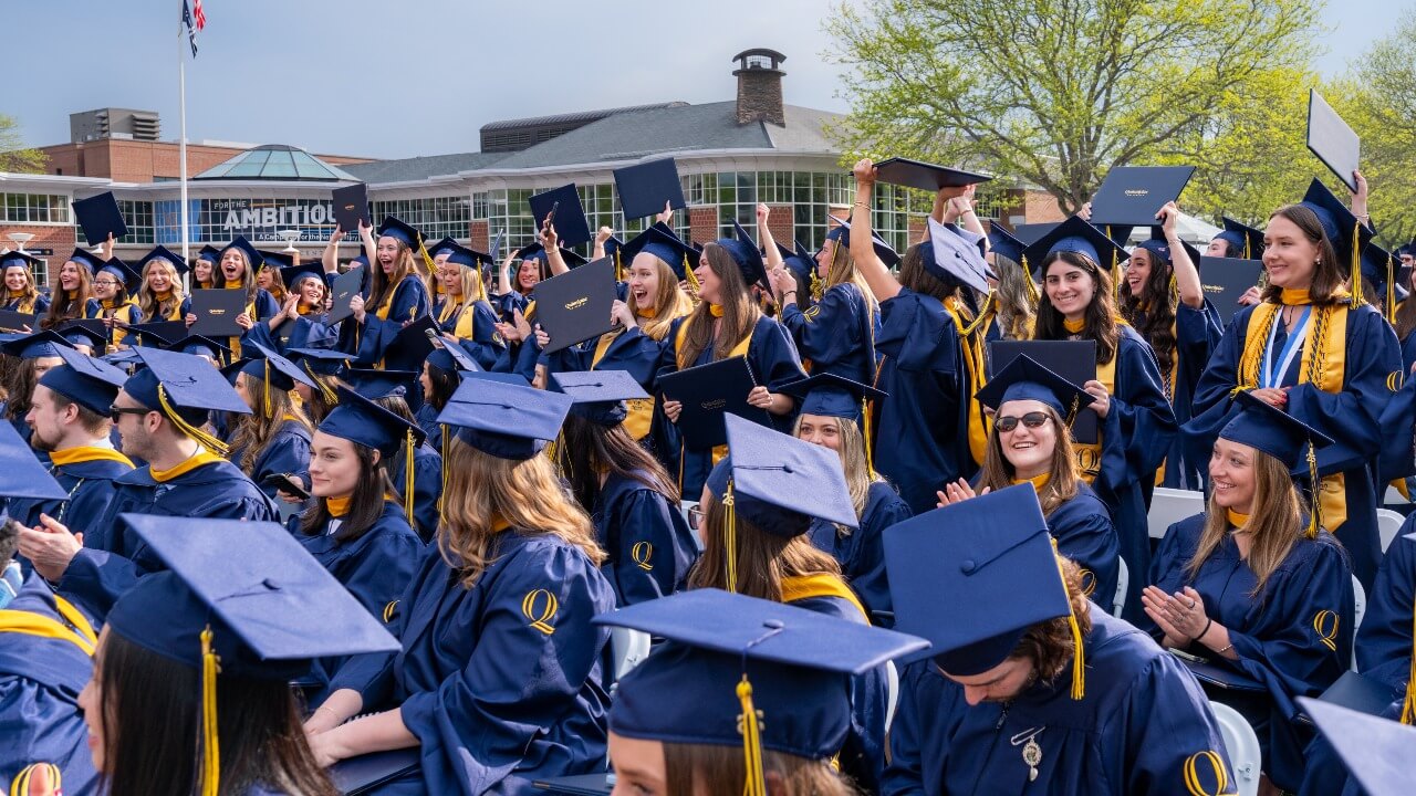 Crowd of graduates cheering and celebrating