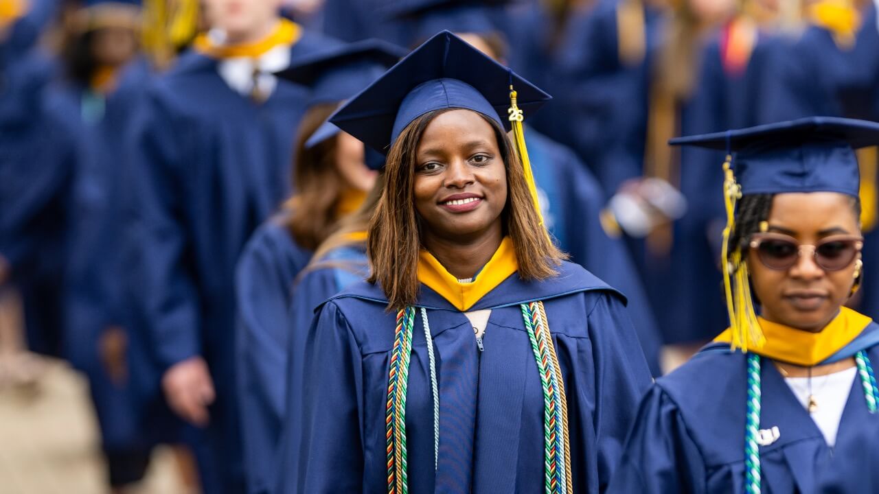 Graduate smiles in line at Commencement