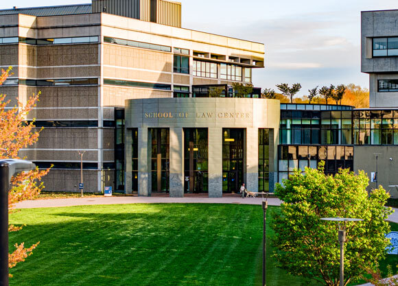 Exterior view of Quinnipiac University’s School of Law Center on the North Haven Campus, surrounded by a lush green lawn.