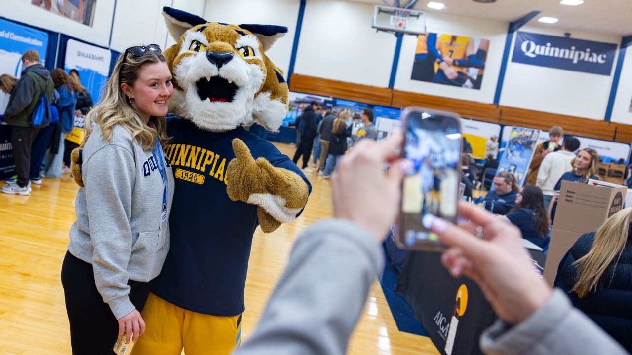 Student taking a photo with Boomer