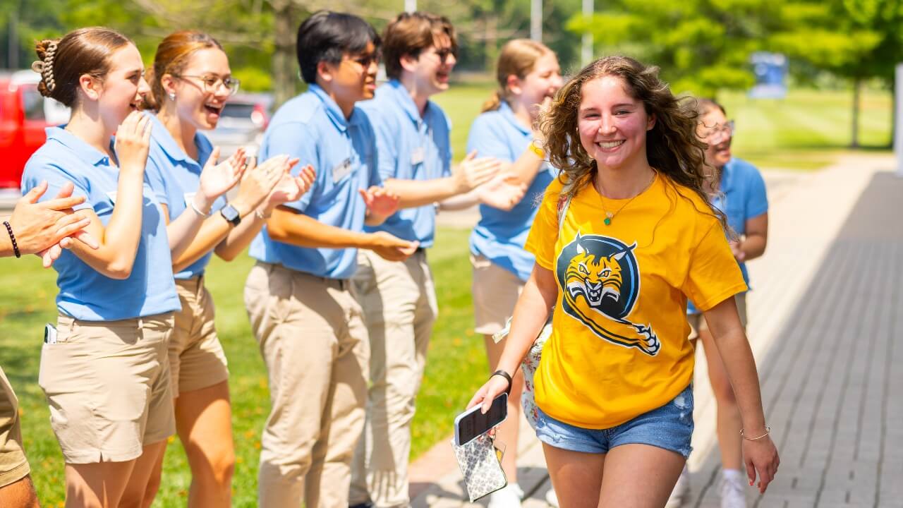 Student walking and smiling at their orientation session