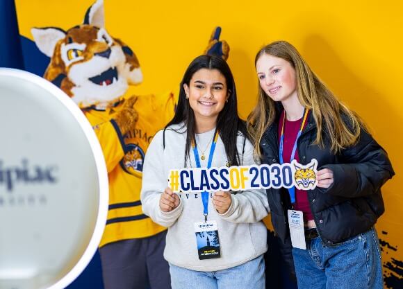 Students posing with a "Class of 2030" sign at Admitted Student Experience