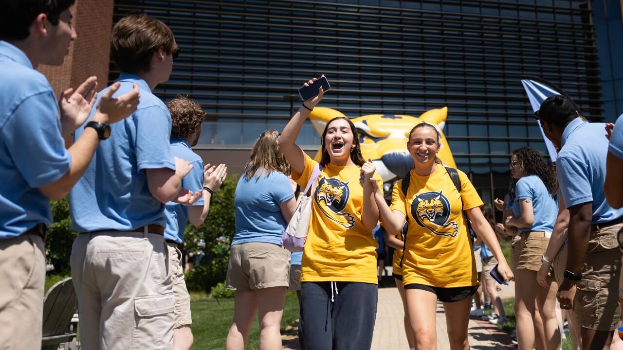 Students smiling as they walk out of Orientation