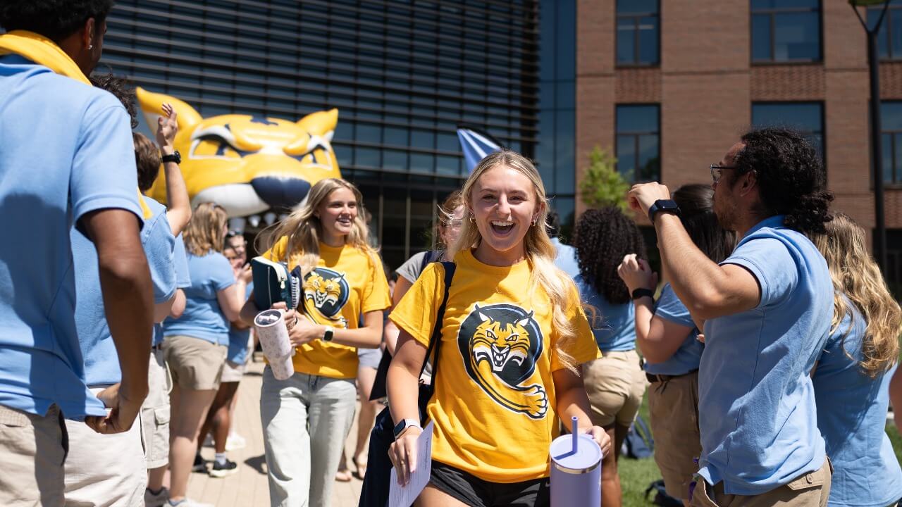 Students smiling as they walk out of Orientation