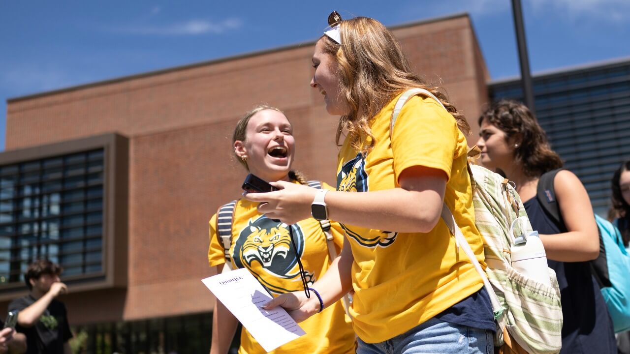 Students laughing as they walk out of Orientation