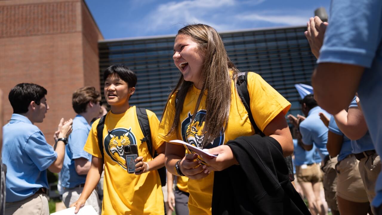 Students laughing as they walk out of Orientation