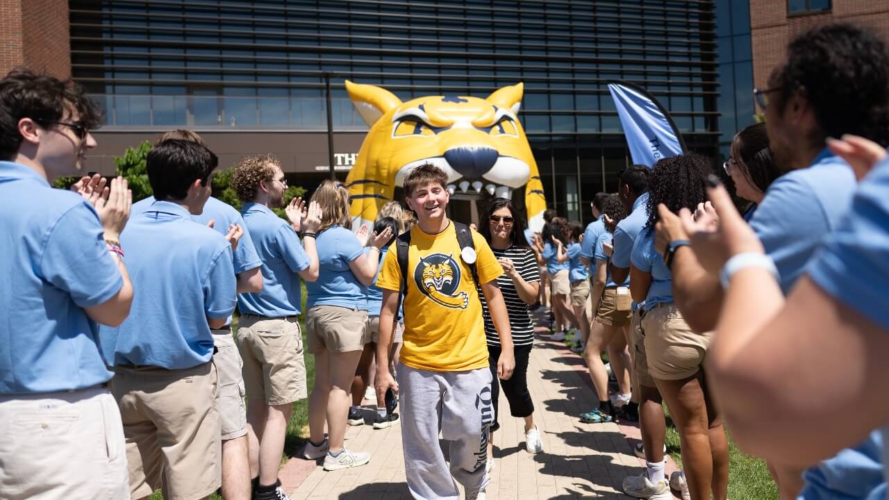 Student smiling while walking out of Orientation