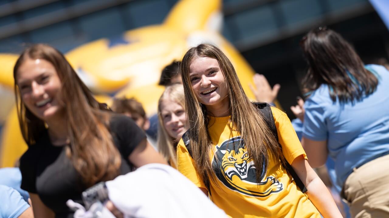 Student smiling while walking out of Orientation