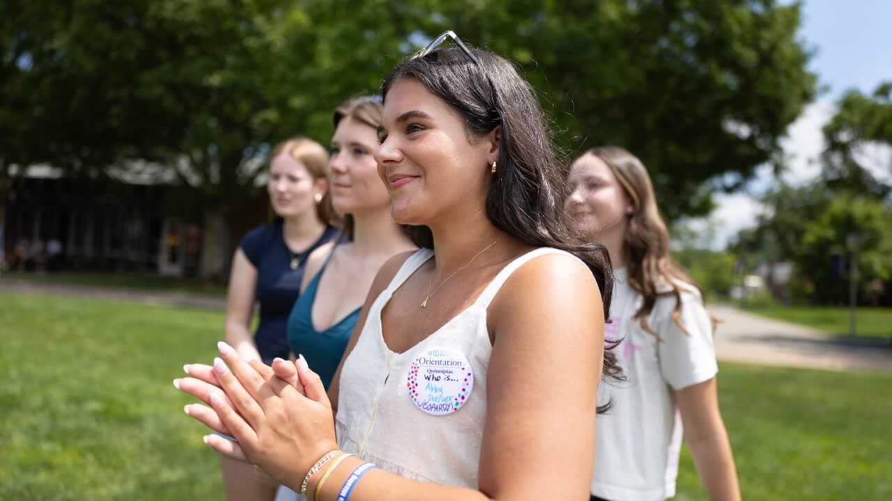 Student smiling at peers at Orientation session