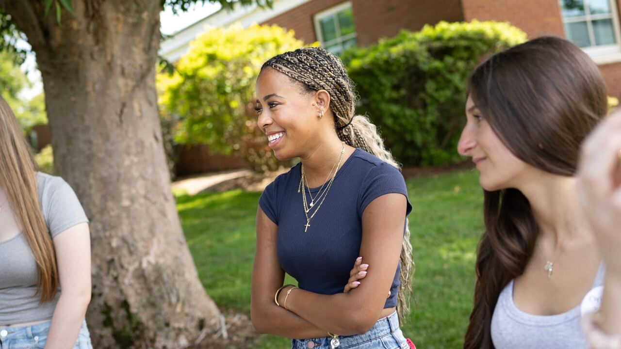 Student smiling at peer during Orientation session