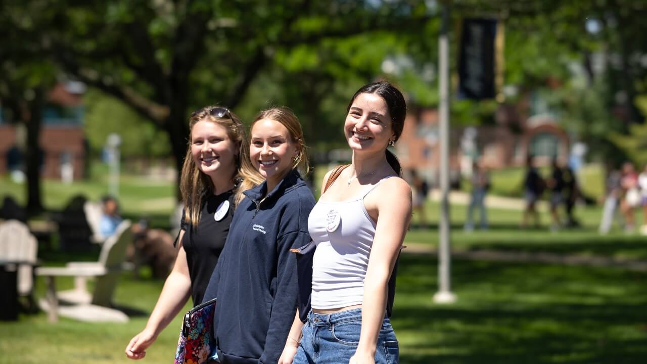 Three students smiling together
