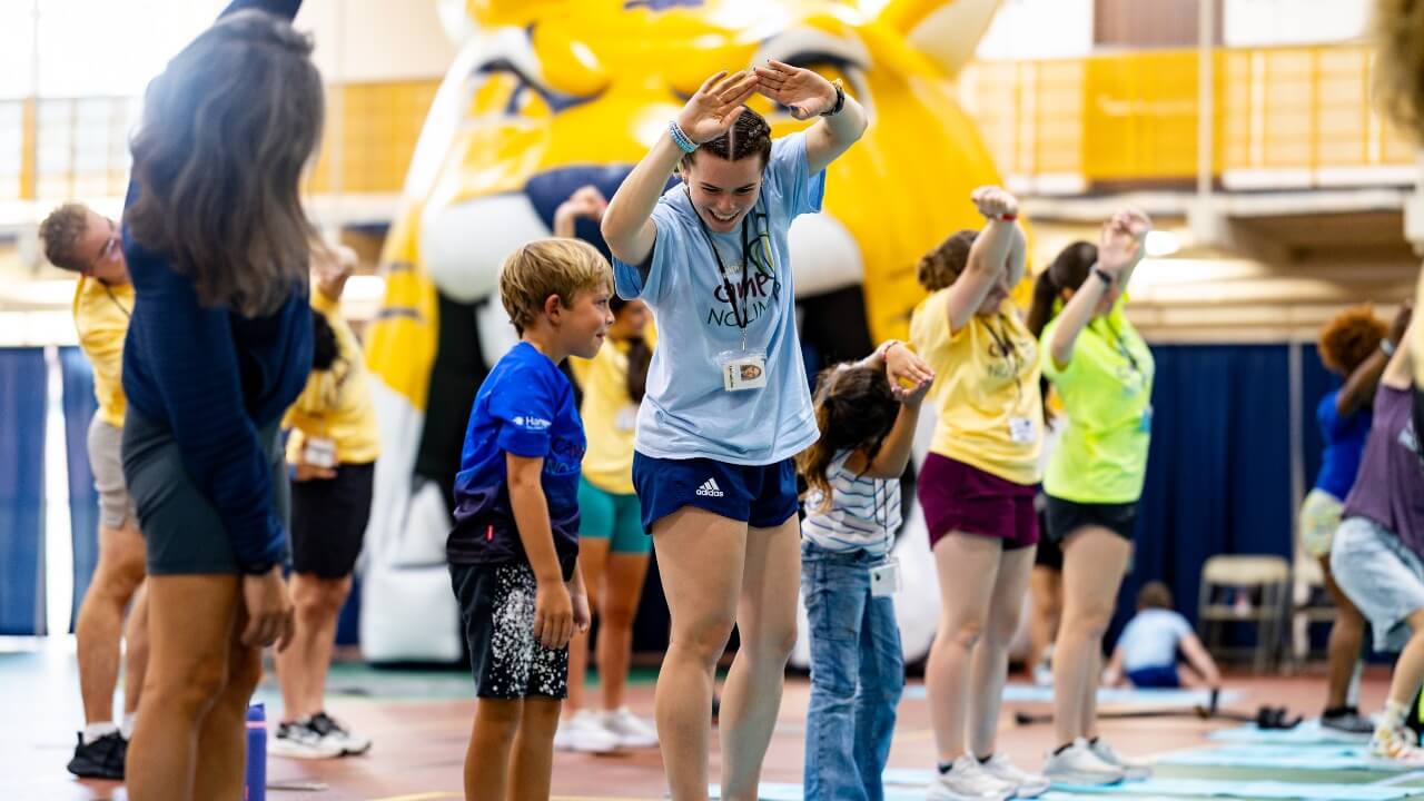 Campers and student leader stretching