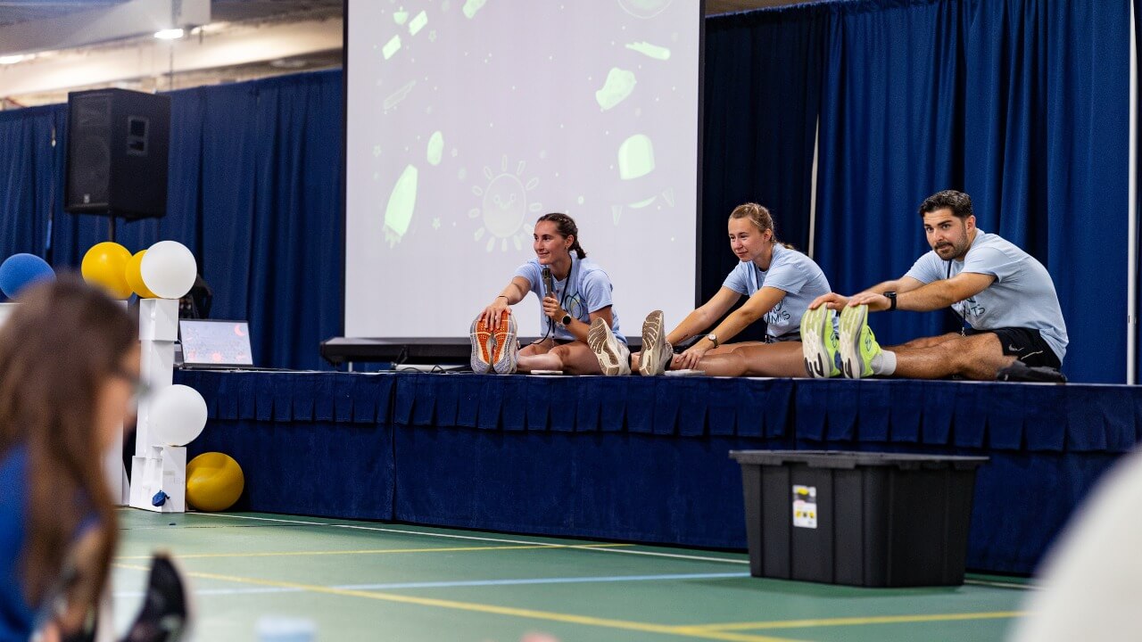 Student leaders demonstrating stretches on stage